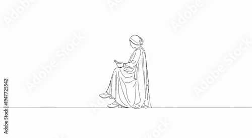 Person in traditional attire, seated, absorbed in a mobile device