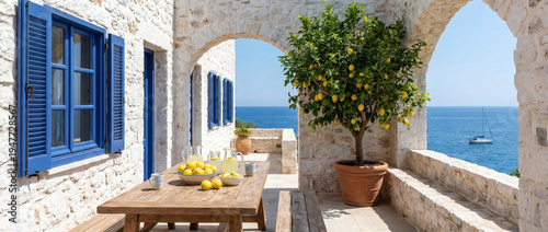 Mediterranean stone house courtyard with lemon tree and sea view under bright sunlight
