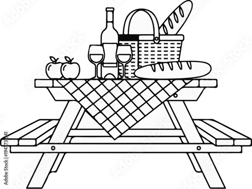 Picnic table laden with wine, bread, apples, and basket