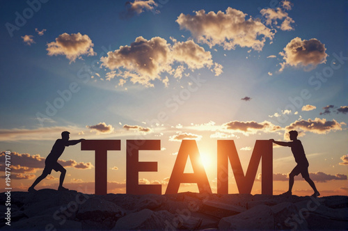 Two men pushing the letters to form the word 