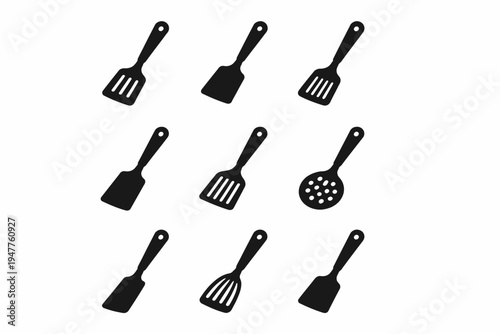 Set of nine black kitchen utensils including spatulas and skimmer