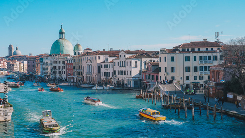 Venice Grand Canal with historic buildings and boats under a clear sky
