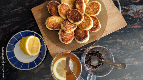 Cuadro en lienzo Platter Of Golden Curd Cheese Pancakes Served With Hot Lemon Tea