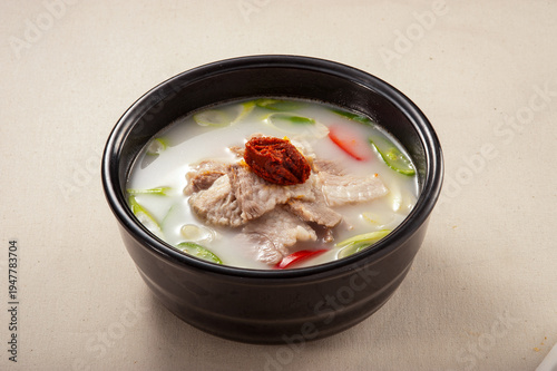 Fotografi Traditional Korean Cuisine: Hearty pork soup (Dwaeji-gukbap) with sliced pork an