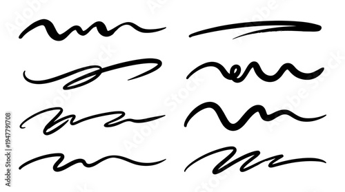 Various black ink brush strokes showcasing artistic lines and curves on a clean background