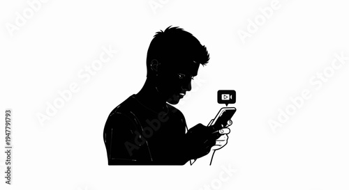 Young person silhouetted, engrossed in mobile phone video playback