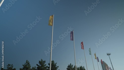 There are many different flags on flagpoles at the stadium. Filmed in slow motion