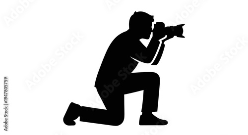 Man kneeling with a camera.