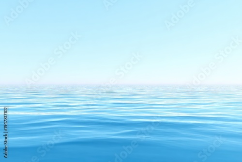 Gentle blue ocean with a cloudless, light sky stretching above horizon line. Peaceful, serene scene