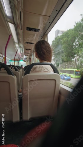 Woman tourist rides a city bus in Singapore. Travel and tourism in Asia, public transport.