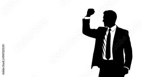 Silhouette of a businessman raising his fist in celebration, success, victory, achievement
