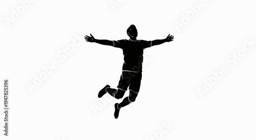 Silhouette of a jubilant athlete leaping with arms outstretched wide