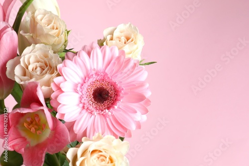 Mother's Day atmosphere concept. Close-up view photo of bouquet of spring flowers on isolated pastel pink background with empty space