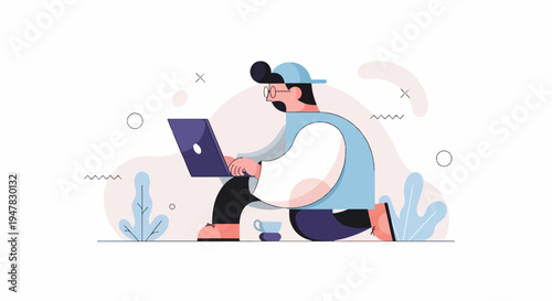 Person with cap and glasses working on a laptop with a coffee cup nearby