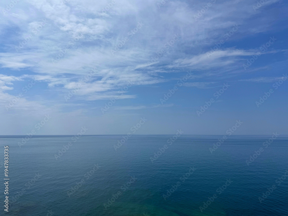Fototapeta premium Open sea with calm water and cloudy sky.