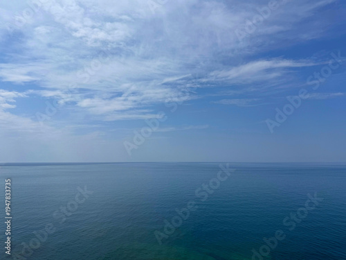 Canvas Print Open sea with calm water and cloudy sky.