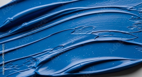 Macro view of glossy blue paint spread in smooth textured strokes with subtle bubbles and highlights, creating an abstract artistic background for design, branding, and creative use. Generative AI.