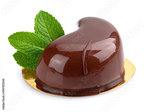 Glossy chocolate dessert with mint garnish, presented on a golden base, isolated on white