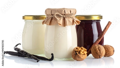 Three glass jars of various fillings, one paper-wrapped, alongside ingredients like nuts, vanilla beans, and a cinnamon stick