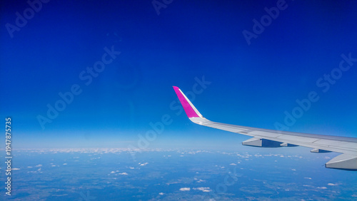 Aftersunset sky, bright blue, dotted with soft white clouds