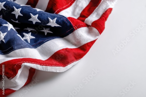 Close-up of a crumpled American flag on a white background, symbolizing patriotism and national pride.