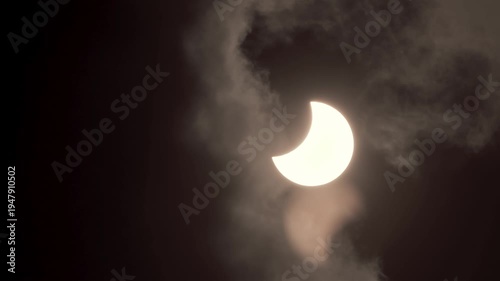 Dramatic Partial Solar Eclipse with Sun Breaking Through Dark Clouds