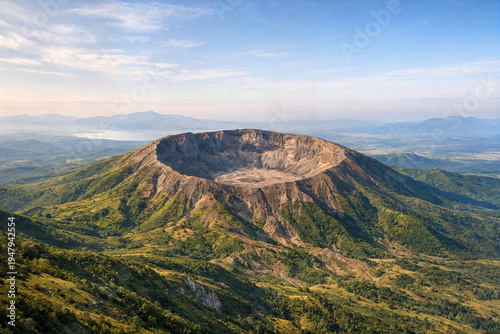 Volcanic crater on forested mountain with rocky interior