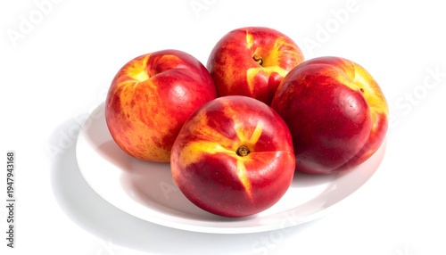 Four ripe, vibrant nectarines are arranged on a white plate against a clean, white background, creating a still-life composition