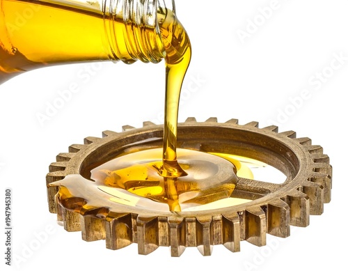 Golden fluid pours from glass bottle onto a rustic cogwheel on a white background, creating a shiny puddle