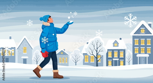 Child in winter coat catching snowflakes in snowy town street, winter season concept