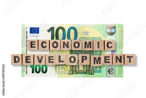 Wooden cubes with word ECONOMIC DEVELOPMENT on a 100 euro background