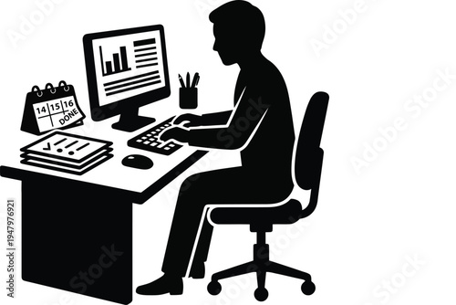 Man sitting at desk working on computer with papers and calendar