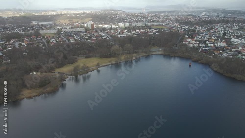 Wallpaper Mural Aerial drone footage showing a lake under moody weather conditions. The scene features calm water, subdued lighting, and overcast skies, presenting a quiet natural landscape with minimal movement and  Torontodigital.ca