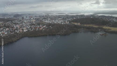 Wallpaper Mural Aerial drone footage showing a lake under moody weather conditions. The scene features calm water, subdued lighting, and overcast skies, presenting a quiet natural landscape with minimal movement and  Torontodigital.ca