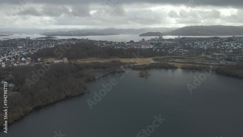 Wallpaper Mural Aerial drone footage showing a lake under moody weather conditions. The scene features calm water, subdued lighting, and overcast skies, presenting a quiet natural landscape with minimal movement and  Torontodigital.ca
