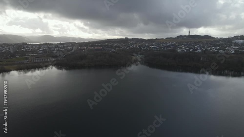 Wallpaper Mural Aerial drone footage showing a lake under moody weather conditions. The scene features calm water, subdued lighting, and overcast skies, presenting a quiet natural landscape with minimal movement and  Torontodigital.ca