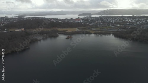 Wallpaper Mural Aerial drone footage showing a lake under moody weather conditions. The scene features calm water, subdued lighting, and overcast skies, presenting a quiet natural landscape with minimal movement and  Torontodigital.ca