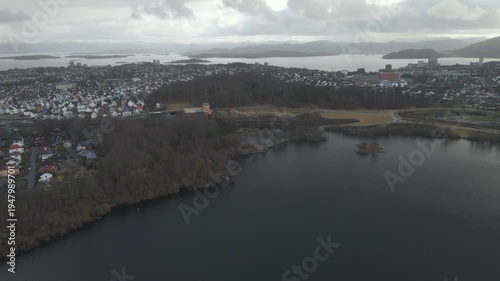 Wallpaper Mural Aerial drone footage showing a lake under moody weather conditions. The scene features calm water, subdued lighting, and overcast skies, presenting a quiet natural landscape with minimal movement and  Torontodigital.ca