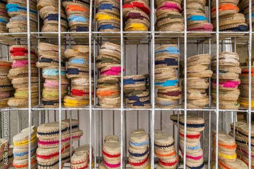 Rows of traditional colorful Spanish espadrilles on a metal rack