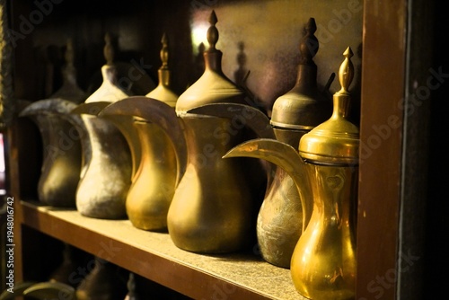 antique coffee pots on a wall