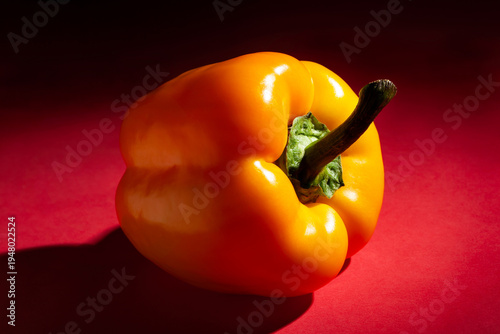 yellow bell pepper on red background