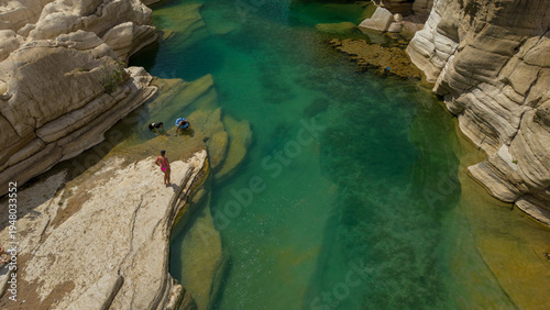 Turquoise river pool in rocky desert canyon