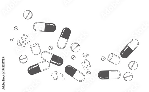 Scattered black and white pills and broken fragments white capsules tablets