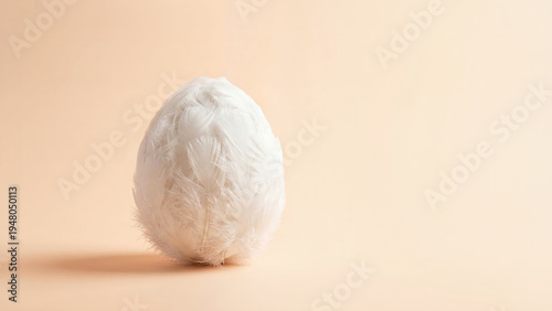 White feather egg standing on soft background, minimal spring symbol concept, delicate natural texture, Easter.