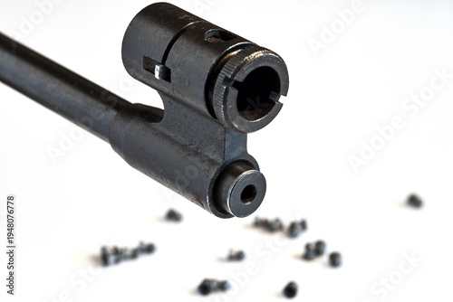 Close-up of the muzzle and diopter sighting device of a 4.5 mm air rifle on a white background
