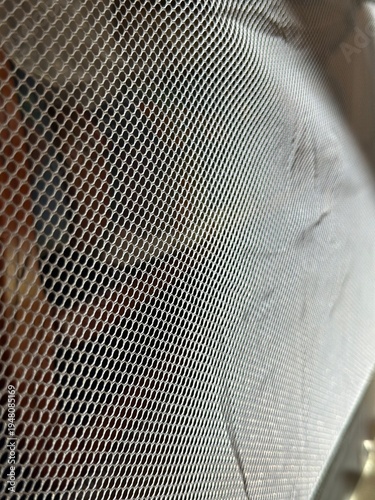 Wallpaper Mural Close-up of gray mesh fabric in sunlight, textured material with small perforated holes. Torontodigital.ca