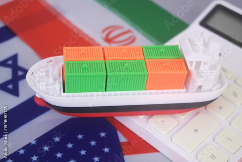 Flags of America, Israel and Iran with container carrier ship on calculator. War between US-Israel and Iran and shipping trough Strait of Hormuz concept.