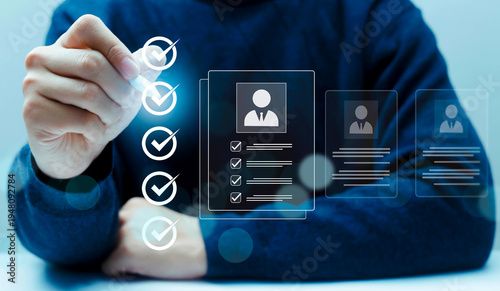 Bild auf Leinwand Hand selecting candidate profile with check mark icons on virtual interface, representing recruitment process, HR screening, employee selection and talent acquisition