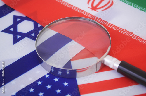 Flags of America, Israel and Iran under magnifying glass. Review war between US-Israel and Iran concept.	