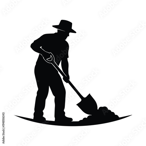 A silhouette of a person shoveling dirt in an outdoor setting